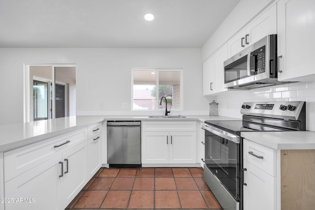 6527 W Sunnyside Dr, Glendale, AZ 85304 - kitchen with white cabinetry, recessed lighting, light countertops, a sink, and stainless steel appliances