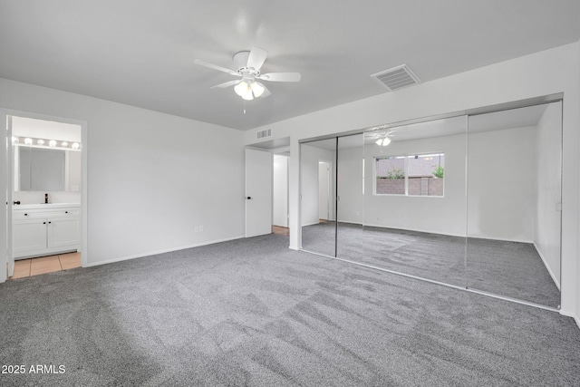 6527 W Sunnyside Dr, Glendale, AZ 85304 - unfurnished bedroom with ensuite bath, a ceiling fan, visible vents, and carpet floors