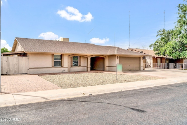 6527 W Sunnyside Dr, Glendale, AZ 85304 - ranch-style home with an attached garage, fence, driveway, and stucco siding