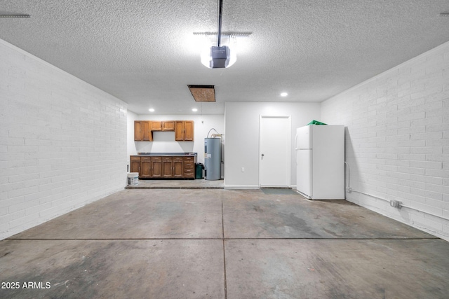 6527 W Sunnyside Dr, Glendale, AZ 85304 - garage featuring recessed lighting, a garage door opener, water heater, and freestanding refrigerator