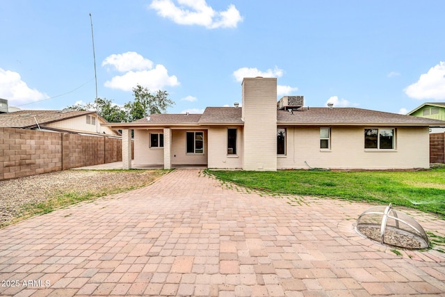 6527 W Sunnyside Dr, Glendale, AZ 85304 - back of property featuring a chimney, a patio area, fence, and a yard