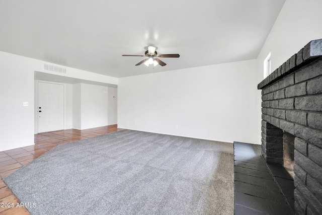 6527 W Sunnyside Dr, Glendale, AZ 85304 - unfurnished living room with a brick fireplace, a ceiling fan, and visible vents