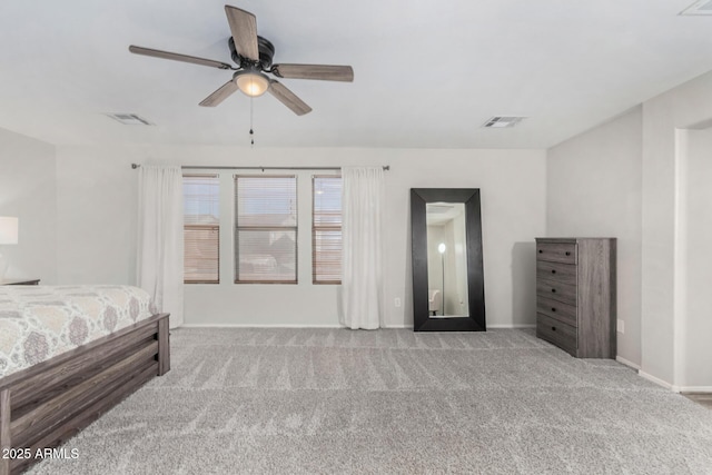 carpeted bedroom with a ceiling fan, visible vents, and baseboards