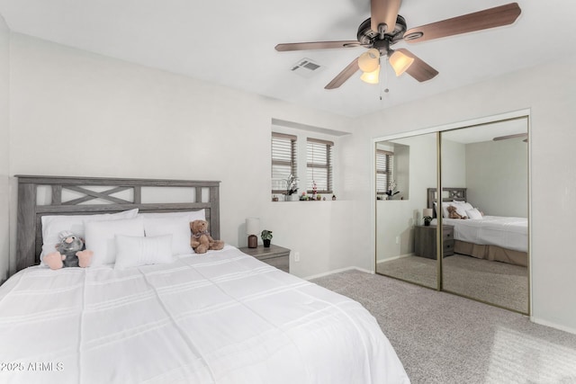 carpeted bedroom featuring a ceiling fan, baseboards, visible vents, and a closet