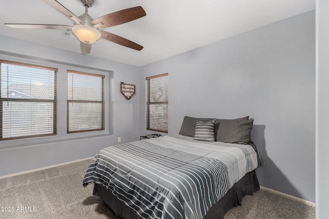 carpeted bedroom featuring ceiling fan and baseboards