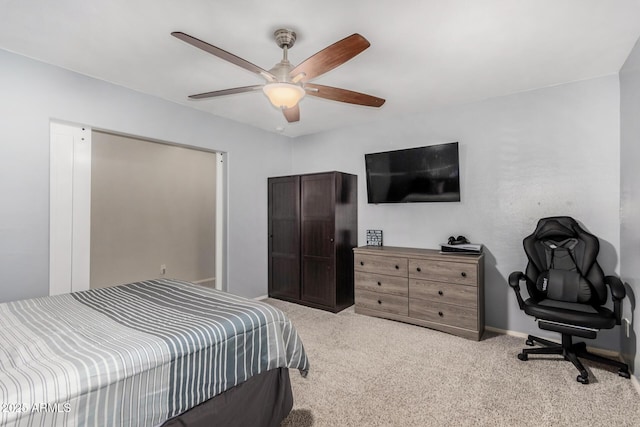 carpeted bedroom with ceiling fan and baseboards