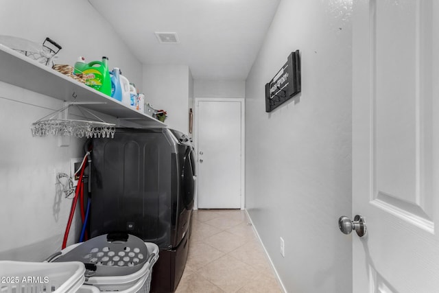 laundry area featuring light tile patterned floors, laundry area, independent washer and dryer, and visible vents