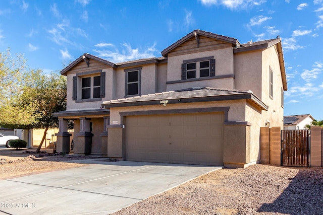 traditional home featuring concrete driveway, a tile roof, an attached garage, and stucco siding