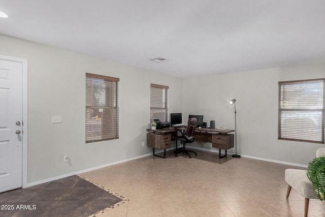 office space with tile patterned floors, visible vents, and baseboards