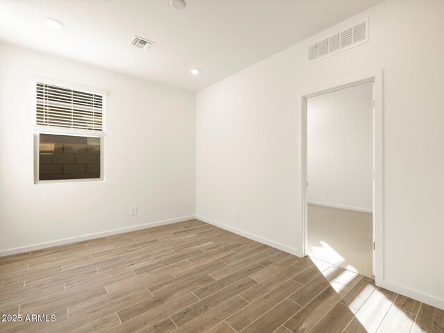 spare room featuring light wood-type flooring