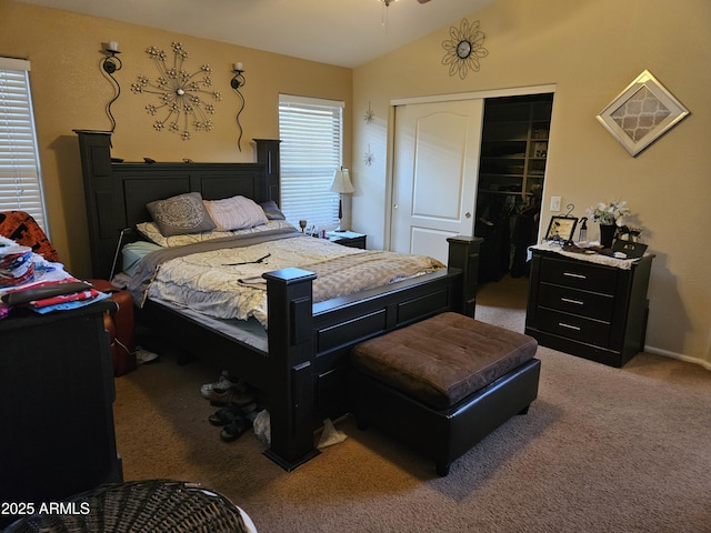 carpeted bedroom with vaulted ceiling and a closet