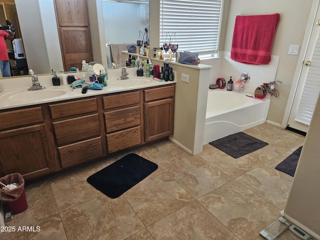 bathroom with tile patterned flooring, vanity, and a bathtub