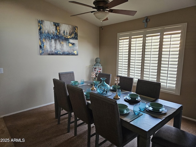 dining space featuring vaulted ceiling, carpet floors, and ceiling fan