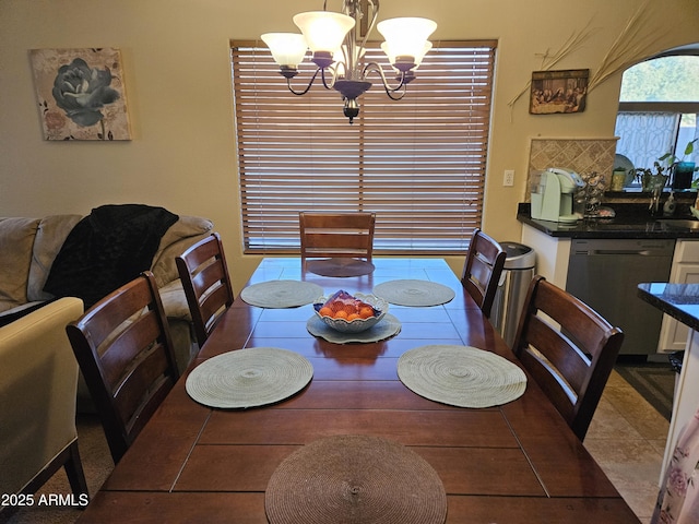 tiled dining space featuring a chandelier