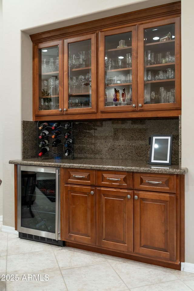 bar featuring a bar, tasteful backsplash, wine cooler, and light tile patterned flooring