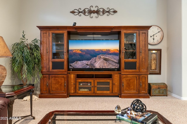 carpeted living area featuring baseboards