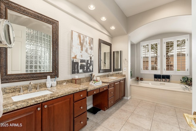 bathroom with tile patterned flooring, a garden tub, vanity, and recessed lighting