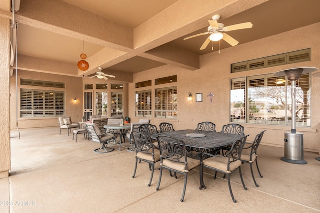 view of patio featuring outdoor dining area and a ceiling fan