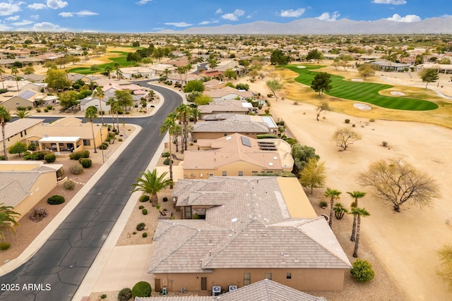 drone / aerial view with a residential view, view of golf course, and a mountain view