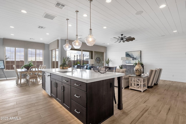 1145 E Gleneagle Dr, Chandler, AZ 85249 - kitchen featuring a sink, a kitchen bar, light wood-style flooring, light countertops, and wood ceiling