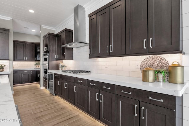 1145 E Gleneagle Dr, Chandler, AZ 85249 - kitchen with wall chimney range hood, crown molding, beverage cooler, stainless steel appliances, and dark brown cabinetry