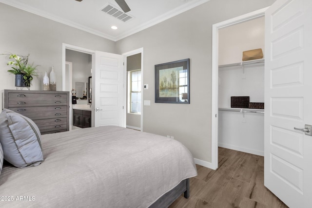 1145 E Gleneagle Dr, Chandler, AZ 85249 - bedroom featuring wood finished floors, ornamental molding, a closet, baseboards, and a spacious closet