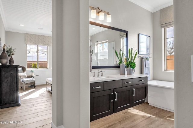 1145 E Gleneagle Dr, Chandler, AZ 85249 - bathroom featuring wood finished floors, vanity, ornamental molding, a soaking tub, and plenty of natural light