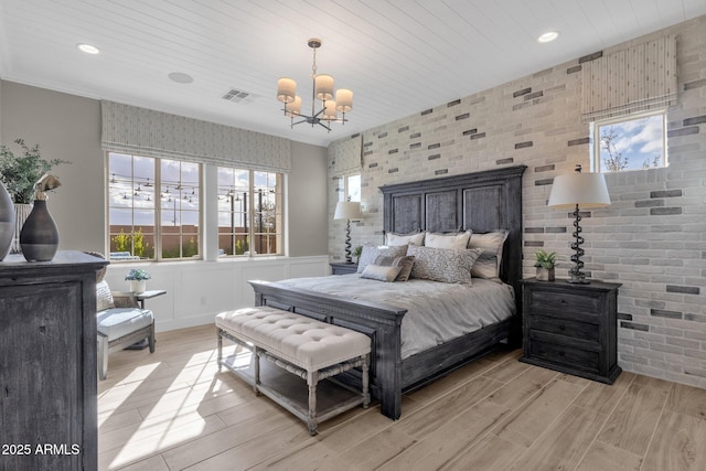 1145 E Gleneagle Dr, Chandler, AZ 85249 - bedroom featuring a chandelier, light wood-type flooring, brick wall, recessed lighting, and wainscoting