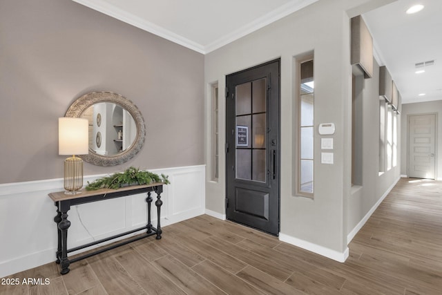 1145 E Gleneagle Dr, Chandler, AZ 85249 - entryway featuring ornamental molding, wood finished floors, a wainscoted wall, and recessed lighting