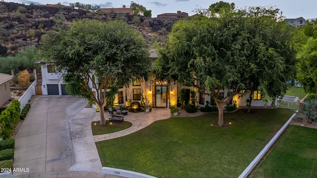 view of front of house with a front yard and a garage