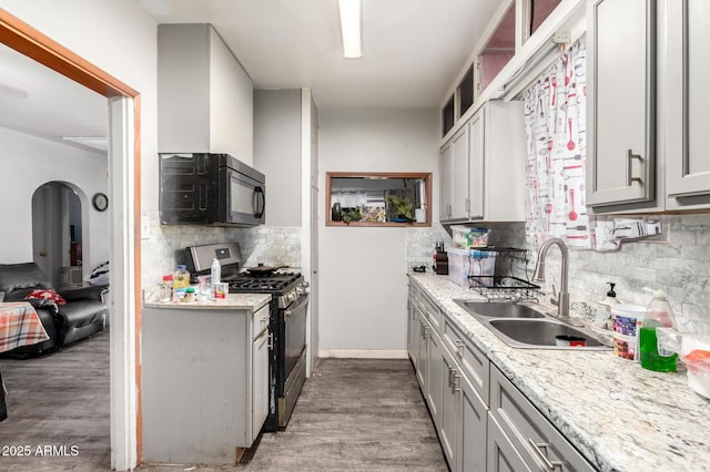 9353 W Monroe St, Tolleson, AZ 85353 - kitchen featuring stainless steel gas stove, a sink, backsplash, wood finished floors, and gray cabinetry