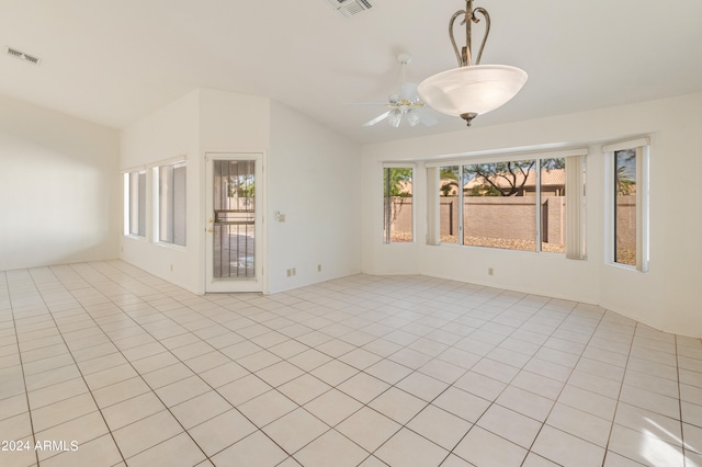 unfurnished room featuring ceiling fan, a healthy amount of sunlight, and light tile patterned flooring