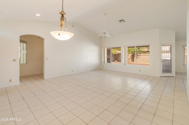 tiled empty room with vaulted ceiling and ceiling fan