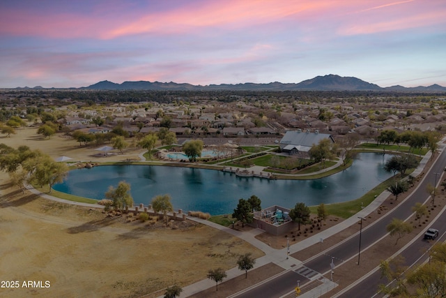 aerial view at dusk with a water and mountain view