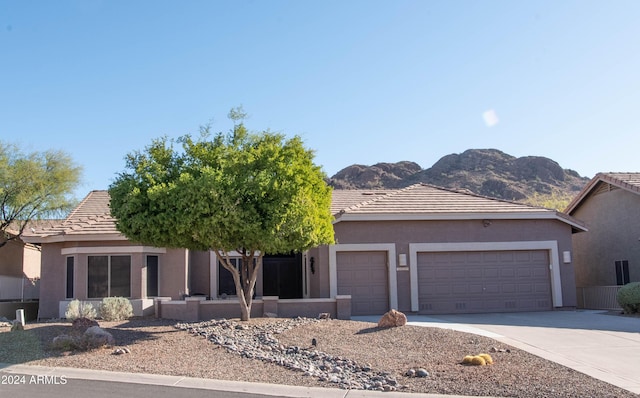 view of front facade featuring a mountain view and a garage