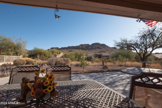 view of patio / terrace with outdoor dining space and a mountain view