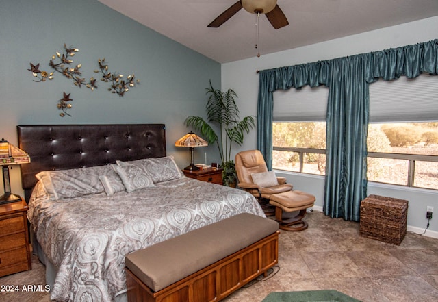 bedroom with a ceiling fan, vaulted ceiling, and baseboards