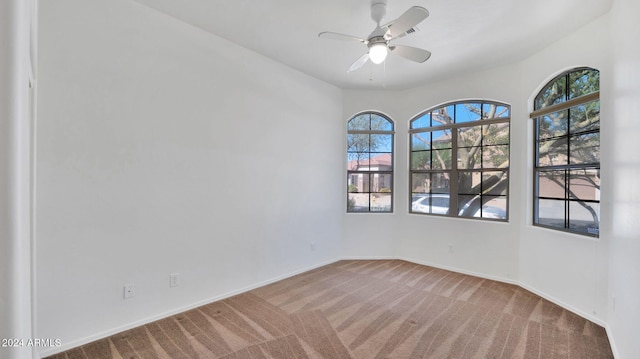 unfurnished room featuring carpet and ceiling fan