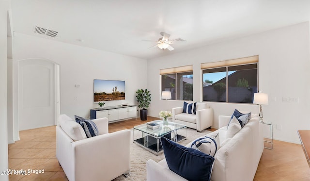 tiled living room with ceiling fan