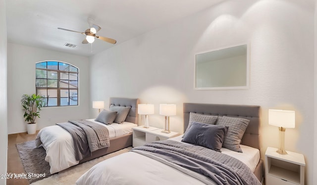 bedroom with light hardwood / wood-style floors and ceiling fan