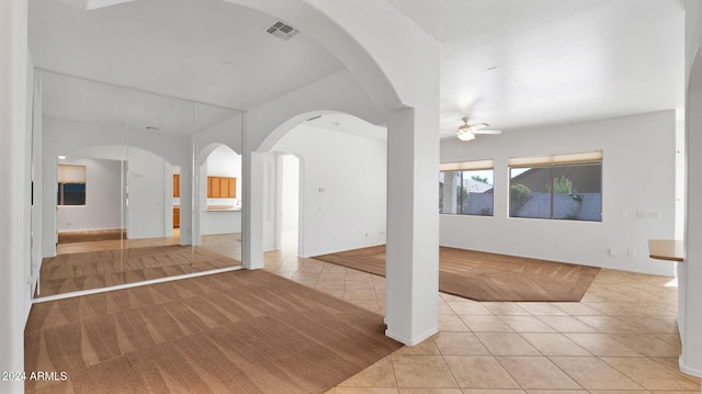 interior space with ceiling fan and light tile patterned floors