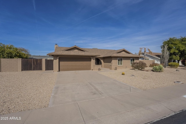 view of front of home featuring brick siding, a chimney, concrete driveway, fence, and a garage