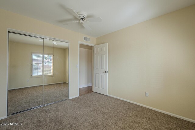 6010 E Greenway Ln, Scottsdale, AZ 85254 - unfurnished bedroom with a ceiling fan, visible vents, baseboards, a closet, and carpet