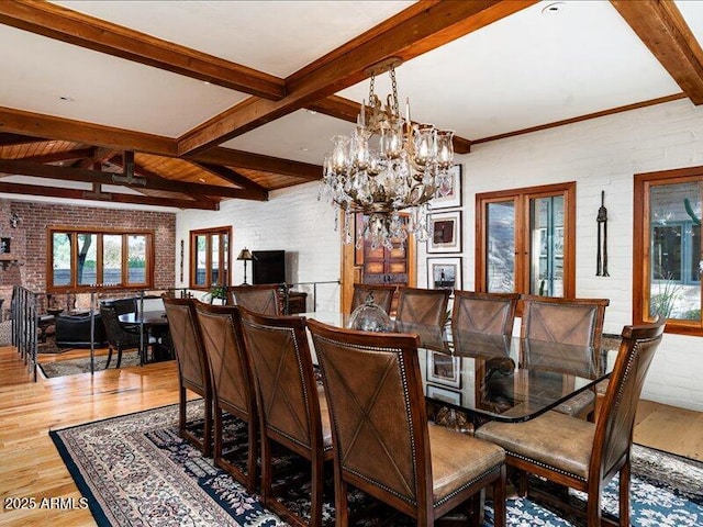 8022 N Ironwood Dr, Paradise Valley, AZ 85253 - dining space with wood finished floors, beam ceiling, healthy amount of natural light, brick wall, and a chandelier