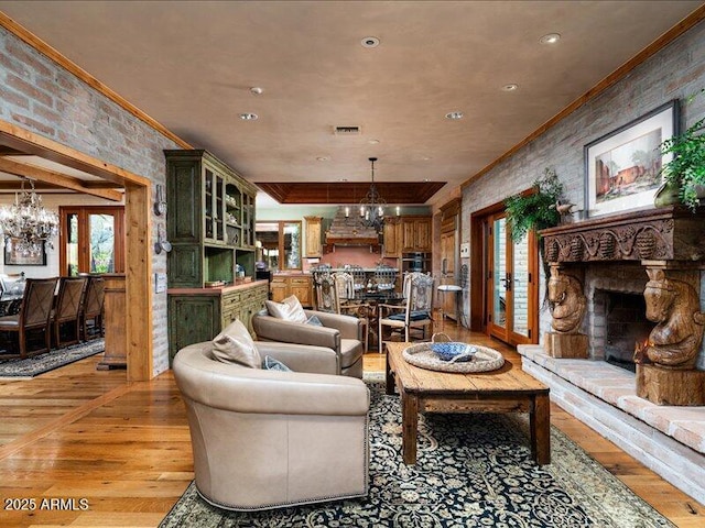 8022 N Ironwood Dr, Paradise Valley, AZ 85253 - living area with a chandelier, ornamental molding, light wood finished floors, a fireplace with raised hearth, and recessed lighting