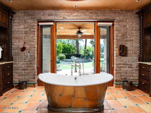 8022 N Ironwood Dr, Paradise Valley, AZ 85253 - bathroom with a soaking tub, brick wall, and ceiling fan