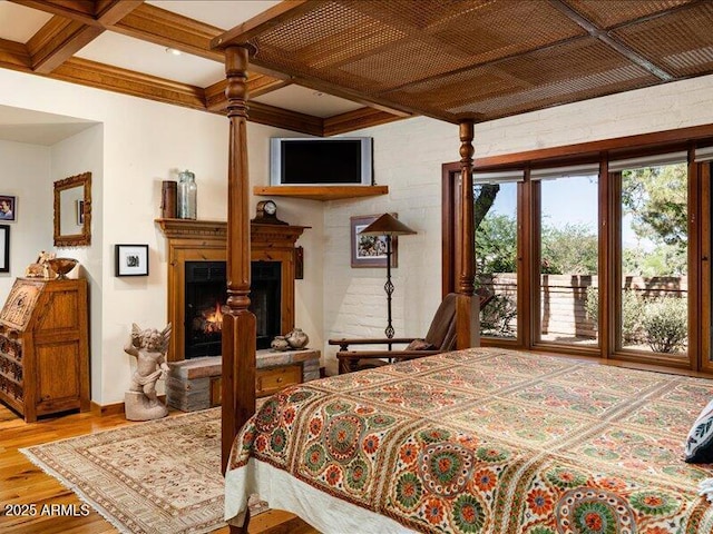 8022 N Ironwood Dr, Paradise Valley, AZ 85253 - bedroom with wood finished floors, access to outside, beam ceiling, a lit fireplace, and baseboards