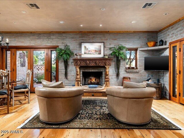 8022 N Ironwood Dr, Paradise Valley, AZ 85253 - living area with a warm lit fireplace, french doors, wood-type flooring, recessed lighting, and brick wall