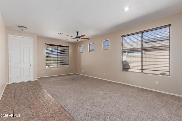 tiled spare room featuring a ceiling fan, visible vents, baseboards, recessed lighting, and carpet flooring