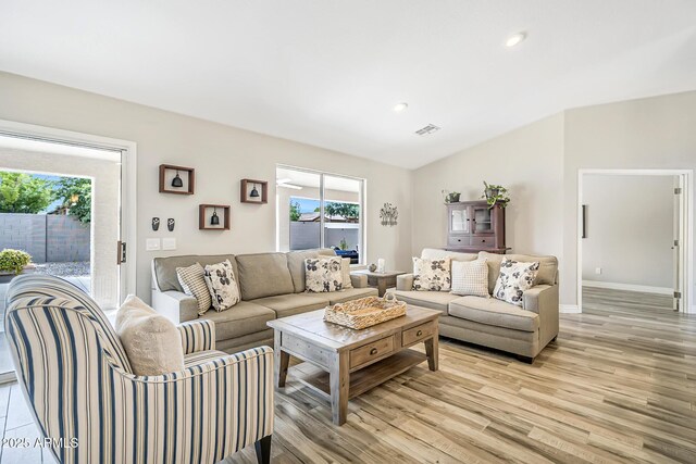 living area with light wood-style floors, vaulted ceiling, recessed lighting, and baseboards